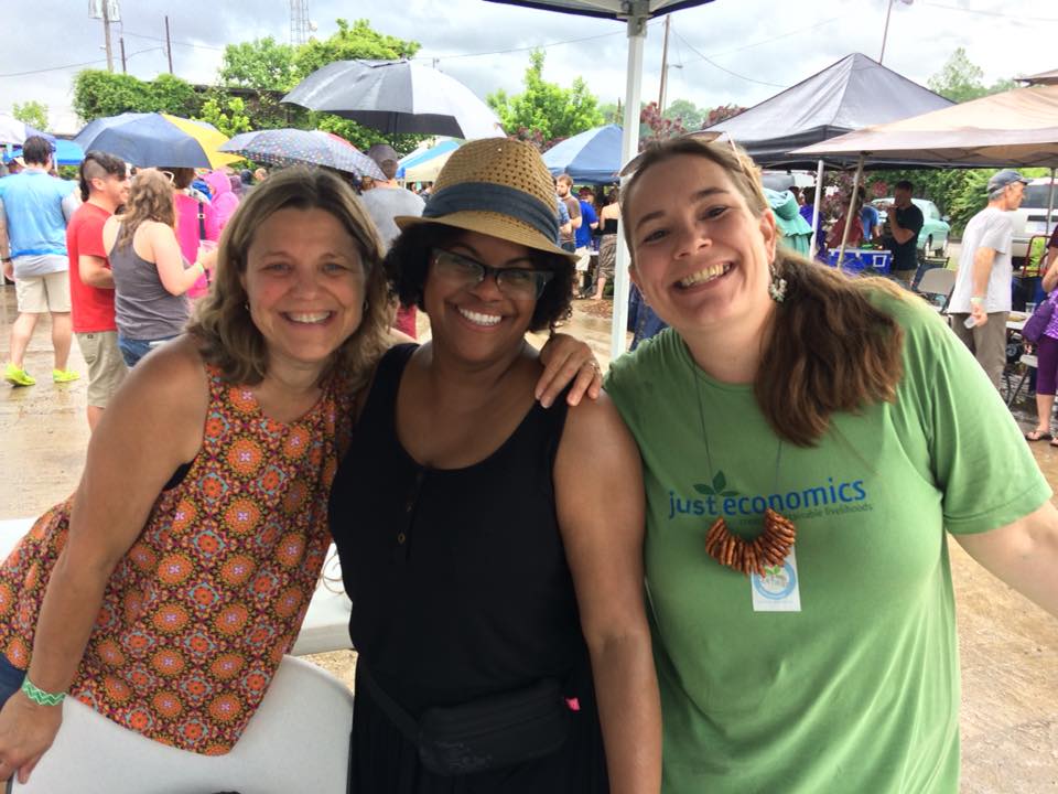 three women standing together smiling